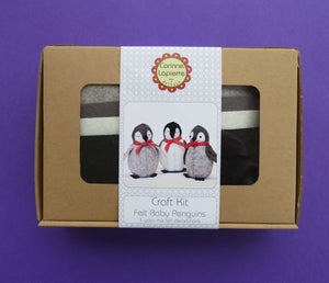 Baby Penguins Felt Craft Kit – sew together a waddle of 3 cute penguins! Three fun penguins felt kit, this box has everything you need to create a waddle (the collective noun for penguins on land) of penguins in a child's bedroom or use as Christmas decorations.  Box shown on purple background