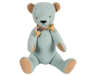 Beautiful Blue Teddy Bear - A timeless gift This beautiful blue teddy bear arrives in a floral cloth bag with a matching floral bow tie around his neck. This classic high quality teddy bear is timeless and will be treasured for years to come. Made with soft velour light blue fabric, he has acrylic bead eyes and an embroidered nose and mouth. Showing bear in sitting position