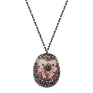 Hand-painted porcelain baby hedgehog necklace This curled up hedgehog necklace is a beautiful gift for someone who loves nature.  The superb intricate design features four pink feet, a black nose, and black eyes.  This necklace is from a range of hand-painted porcelain necklaces that have amazing detailed features. 