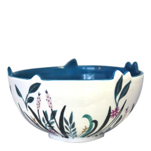 Side view of Swan Bowl. A lovely Swan Bowl - perfect for trinkets, jewellery or treats This elegant swan bowl depicts a pretty riverbank with floral designs decorating the outside of this bowl. Inside, there's a deep blue colour representing the water with gold dots glistening on the surface. A regal white swan wearing a gold crown, shelters at the bottom of the bowl.