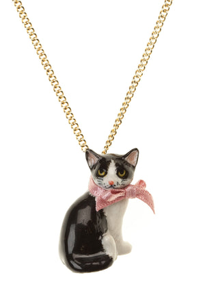 Black and White Cat Necklace - beautifully designed porcelain cat necklace with a pink bow. Intricate detailed features with yellow eyes and pink nose and whiskers. Handpainted. Designed in Scotland